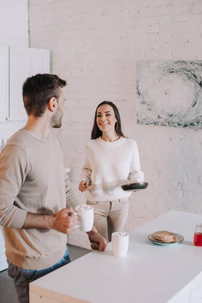 istock beautiful young couple making breakfast together at home 1065395698