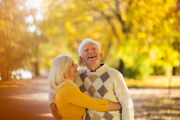istock Elderly couple together in autumn park 1065396924
