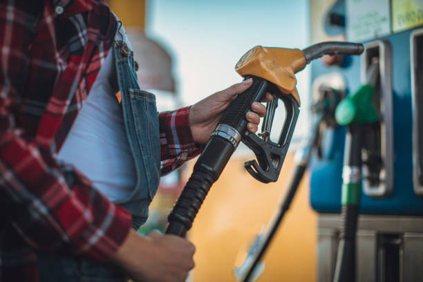 istock Girl hand holding a fuel pump 1065397084