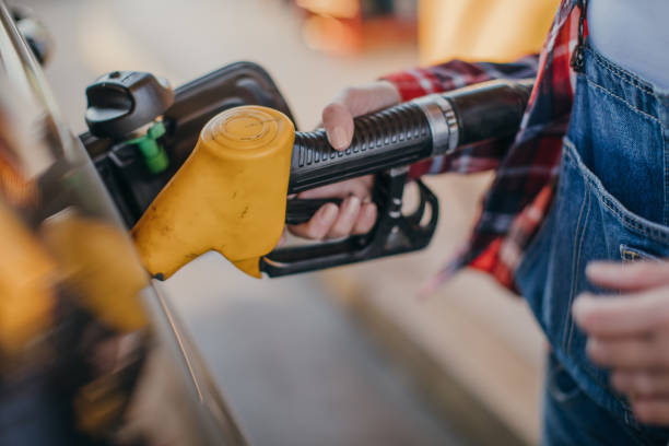 istock Lady holding a fuel pump 1065397376