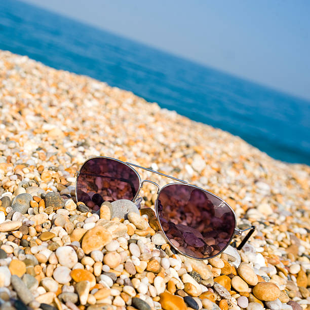 Pair Of Sunglasses Lying On The Beach stock photo