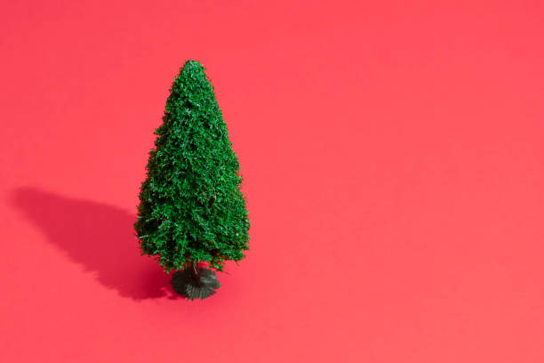 istock Minimal composition background of green Christmas tree on pastel red. 1065412076