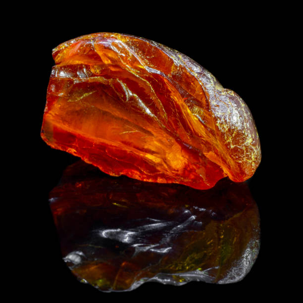 istock Natural piece of amber on a black background with reflection 1065416944