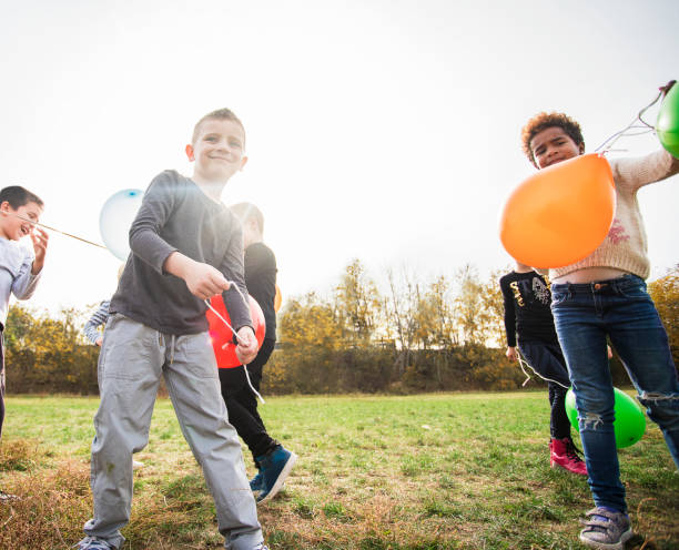 istock Cheerful kids playing with balloon's 1065417432