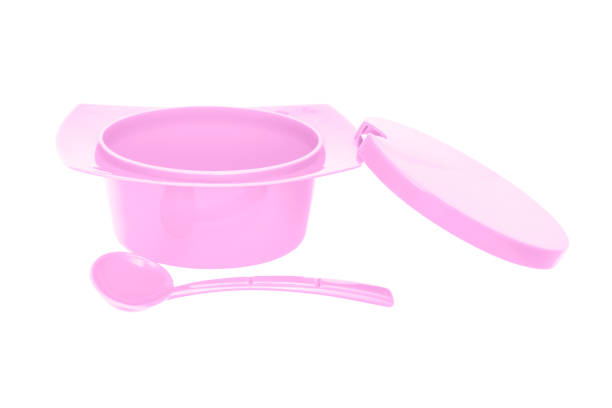 istock Color plastic sugar bowl with spoon on white background 1065424804