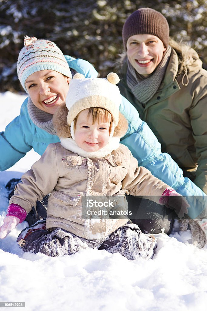 Happy family playing in the snow Joyful family enjoying time in winter park Adult Stock Photo