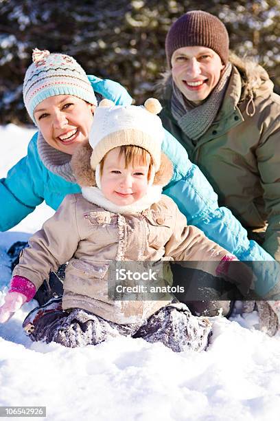 Happy Family Playing In The Snow Stock Photo - Download Image Now - Adult, Beautiful People, Cheerful