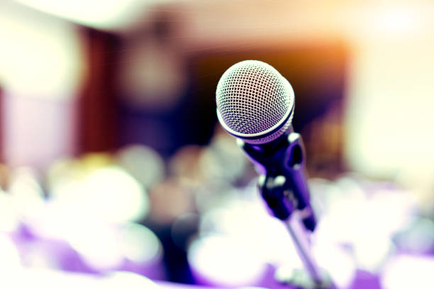 istock Microphone in the empty purple conference room before the meeting. 1065432426