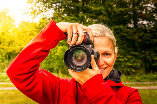 istock Woman with digital camera taking pictures 1065433430