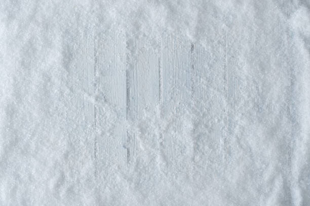 istock White wooden table background with snow. 1065433718