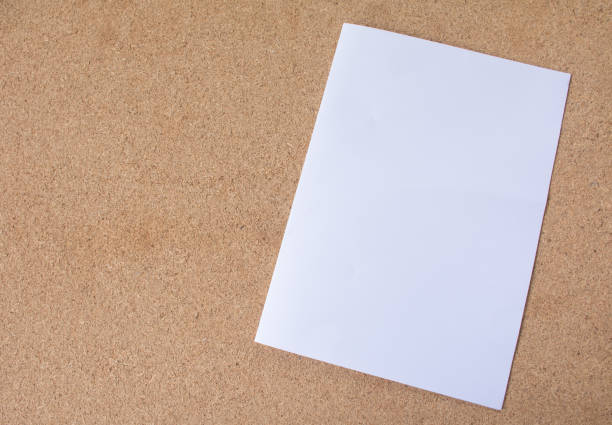 istock A4 White Paper on plywood texture. 1065436696