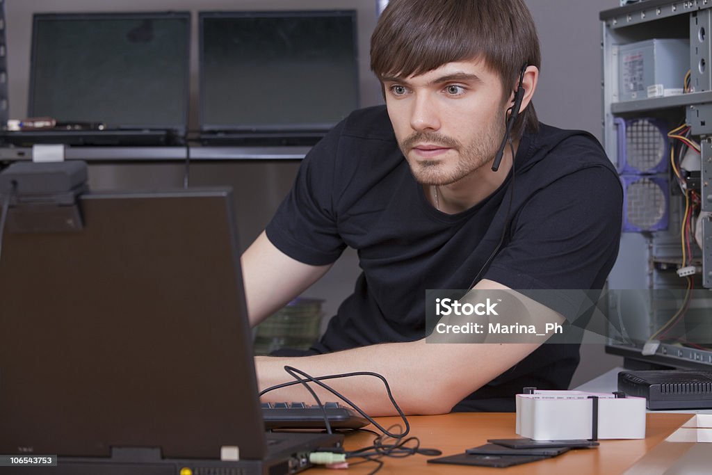 Young male with headset using computer  Adult Stock Photo