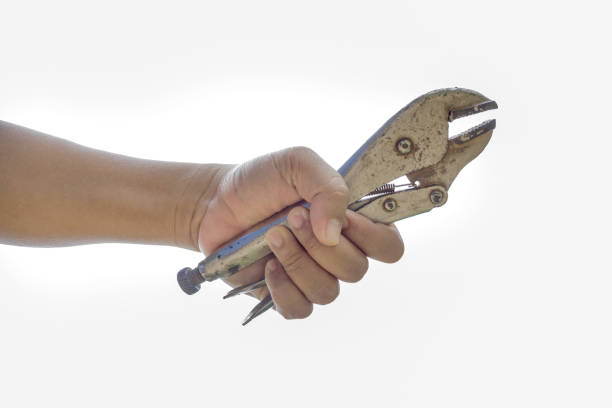 istock A hand holding locking grip pliers on white background. 1065437608
