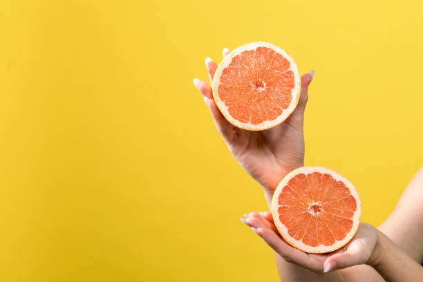 istock Young woman holding oranges 1065443928