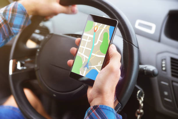 istock Consulting a route on a smartphone in a car closeup 1065447778