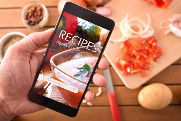 istock Using digital cookbook app in smartphone for cooking closeup 1065447824