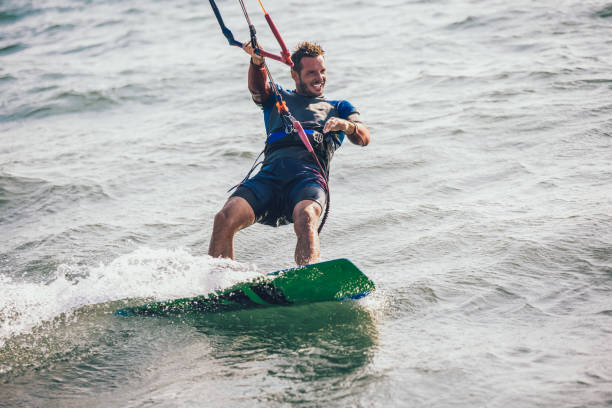 istock Kitesurfing Kiteboarding action photos man among waves quickly goes 1065447862