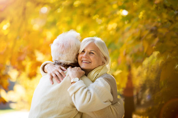 istock Elderly couple together in autumn park 1065450374