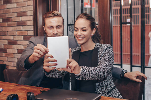 istock Happy colleagues taking selfie with digital tablet 1065450868