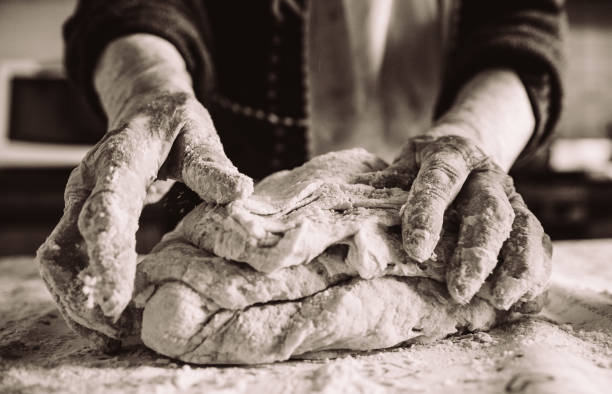 old italian  lady's hands making home made italian pasta stock photo
