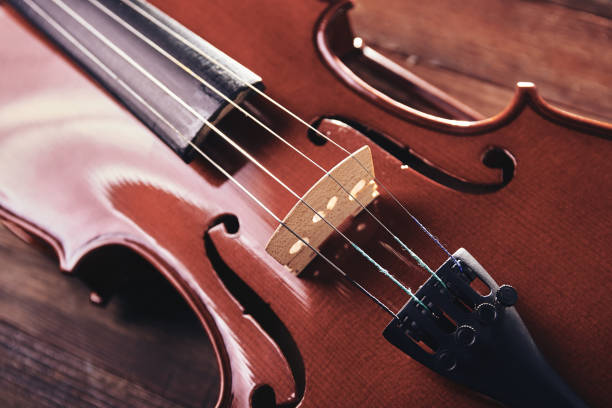 istock violin  on a wooden background 1065453446