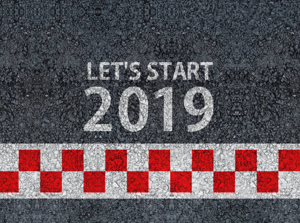 istock lets start 2019 and racing start line written on an asphalt road 1065453912