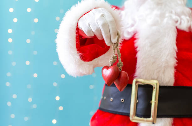 istock Santa holding Christmas hearts 1065458010