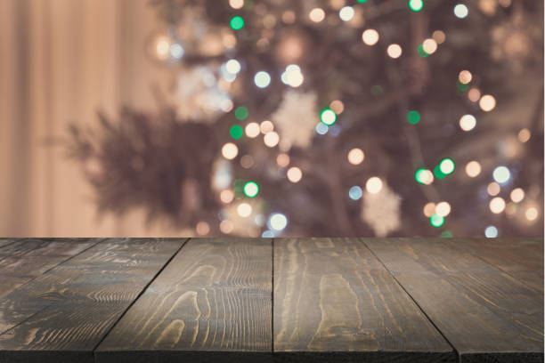 istock Wooden tabletop and blurred christmas tree in interior. Xmas background for display your products. 1065458842
