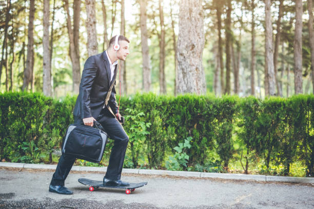 istock Young businessman going to work with skateboard. 1065458932