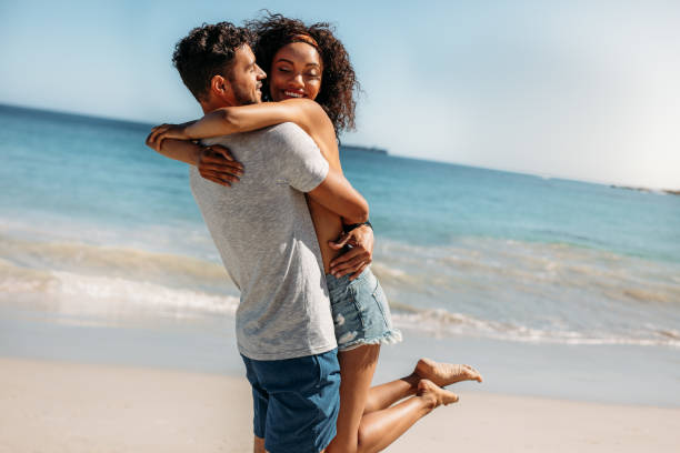 istock Romantic couple having fun at the beach 1065465376