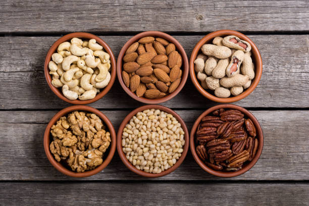 istock Mix of nuts : Pistachios, almonds , walnuts , pine nut , hazelnuts and cashew . Snack in bowl backgrond 1065467680