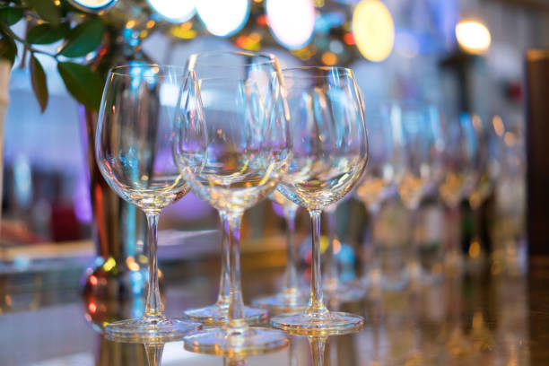 istock glass of empty wine at a party filled with lights. 1065469236