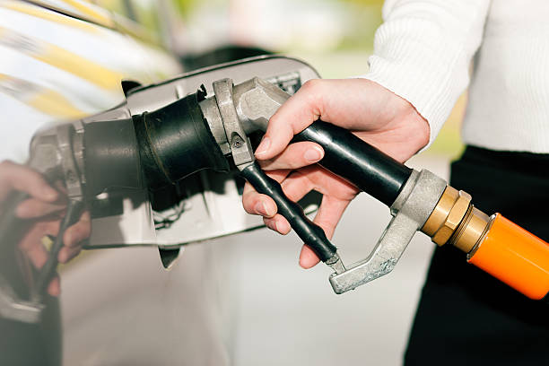 Woman refueling car with LPG gas stock photo