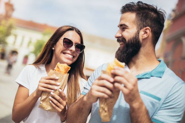 istock Young couple is eating sandwiches and having a great time 1065477438