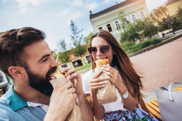istock Young couple is eating sandwiches and having a great time 1065478116