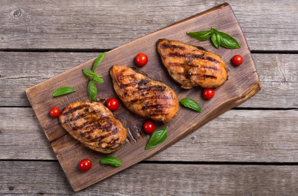 istock Grilled chicken breast ( fillet ) with basil and tomatoes 1065482310
