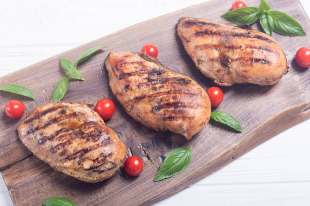 istock Grilled chicken breast ( fillet ) with basil and tomatoes 1065482332
