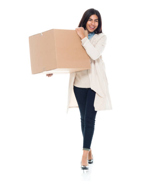 istock Attractive young latino female is holding a box 1065483328