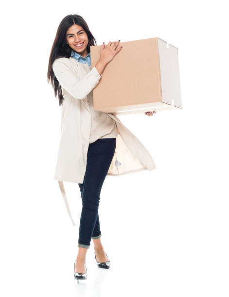 istock Attractive young latino female is holding a box 1065483356