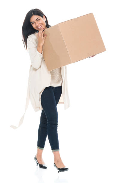 istock Attractive young latino female is holding a box 1065483362