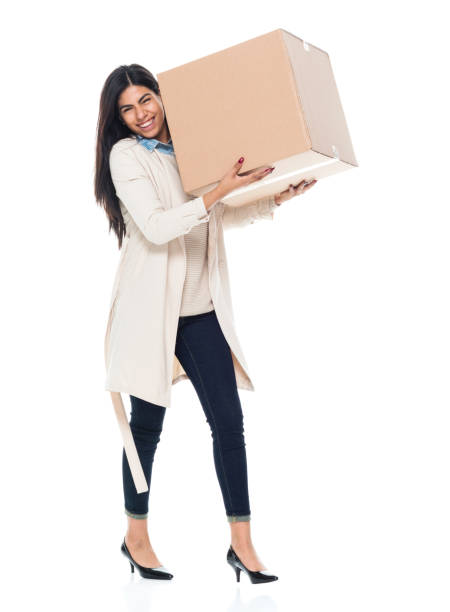 istock Attractive young latino female is holding a box 1065483422