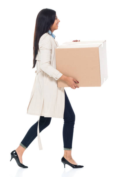 istock Attractive young latino female is holding a box 1065483530