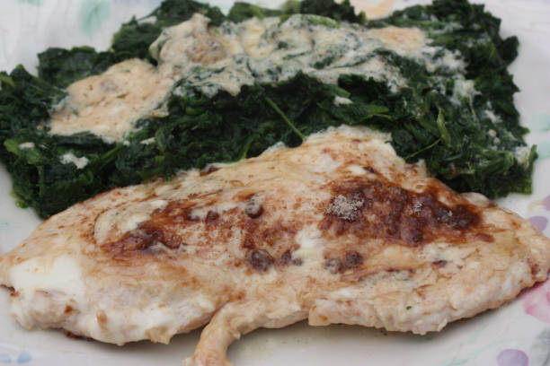 istock Turkey escalope with cream served with spinach 1065483742