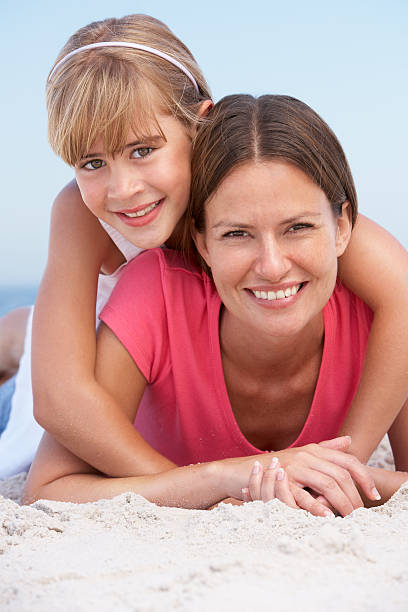 istock Mother And Daughter Relaxing On Beach Holiday 106548665