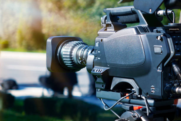 istock Video camera - recording show outdoor TV studio - focus on camera aperture 1065488004