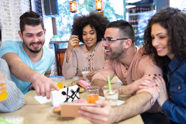 istock Young people taking selfie in cafe 1065490368
