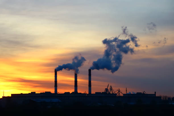 istock chimney emission on background a sunny dawn 1065492788