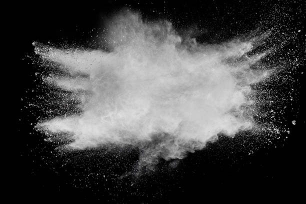 istock Bizarre forms of white powder explosion cloud against black background.White dust particles splash. 1065492906