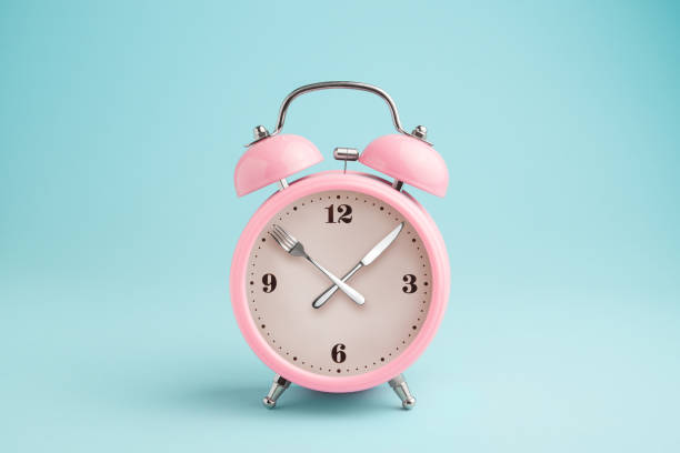 istock Alarm clock. Fork and knife instead of clock hands 1065494824