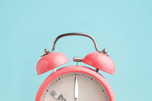 istock Alarm clock. Fork and knife instead of clock hands. 1065494838